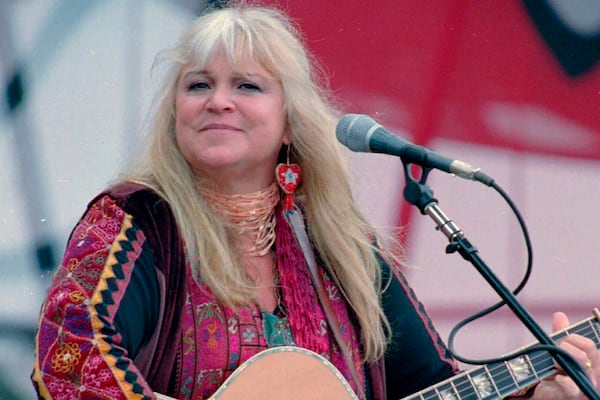 FILE - Melanie Safka, who performed at the original Woodstock decades ago, opens the second day of the festival "Day In The Garden," in Bethel, N.Y., Aug. 15, 1998. (AP Photo/Ken Bizzigotti, File)