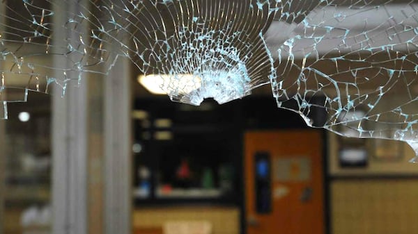 The top of a bullet hole can be seen in the shattered plate glass window through which Adam Lanza gained access Dec. 14, 2012, to Sandy Hook Elementary School in Newtown, Connecticut. Documents from the investigation into the Sandy Hook shooting are shedding light on Adam Lanza’s anger, scorn for other people and deep social isolation in the years leading up to the shooting. He fatally shot his mother, Nancy Lanza, at their home before driving to the school, where he killed 20 children and six educators before killing himself.