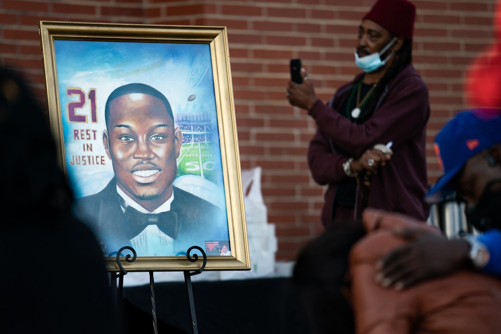 A painting of Ahmaud Arbery is displayed during a vigil at New Springfield Baptist Church on Feb. 23, 2021 in Waynesboro, Ga. Arbery, a Black man, was shot and killed while jogging near Brunswick, Ga., after being chased by three white men. (Sean Rayford/Getty Images/TNS)