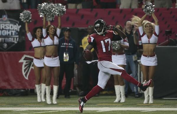 Atlanta Falcons wide receiver Devin Hester (17) runs back a punt toward the end zone for a touchdown after against the Tampa Bay Buccaneers during the first half of an NFL football game, Thursday, Sept. 18, 2014, in Atlanta. (AP Photo/John Bazemore)