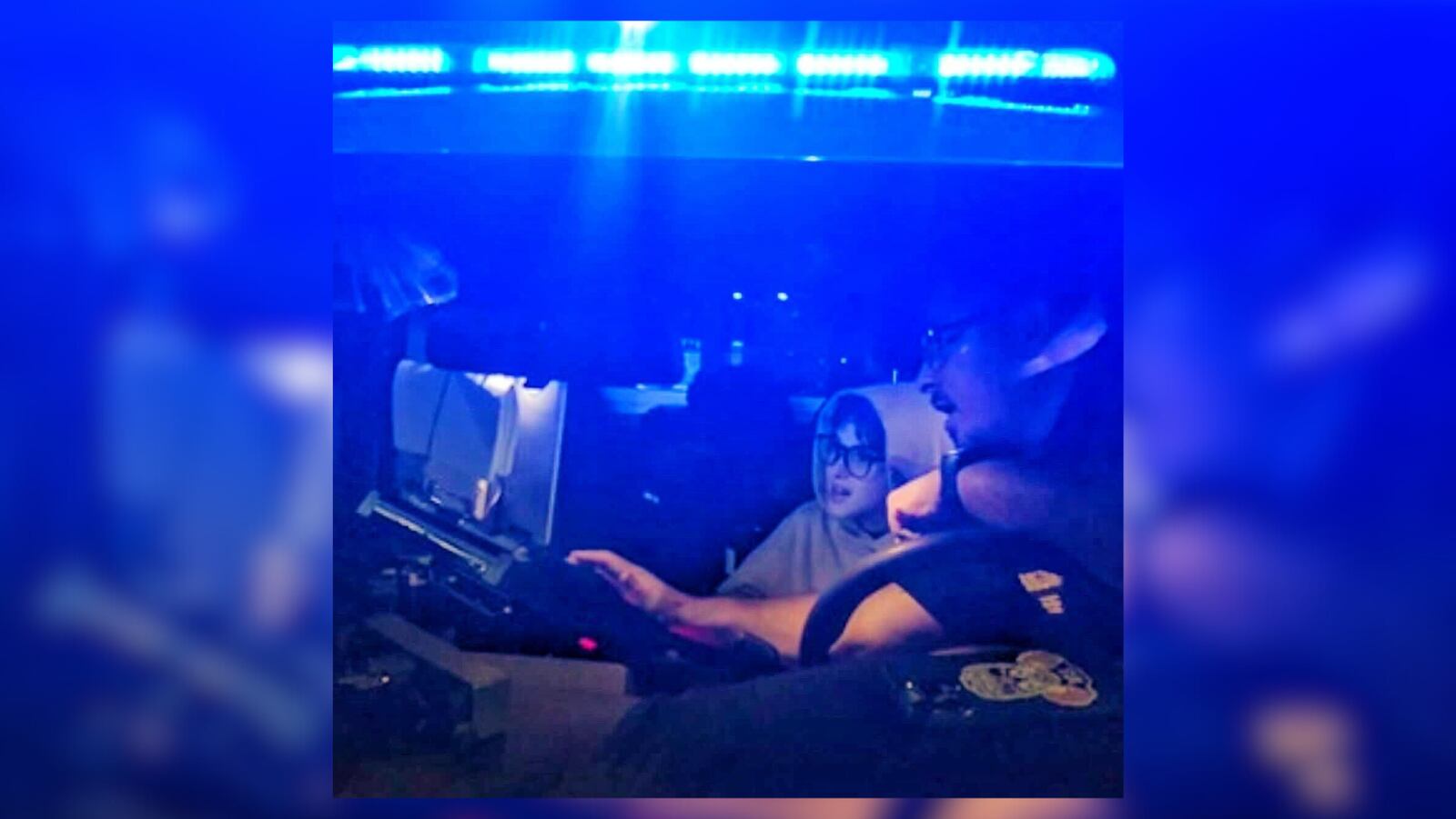 Sgt. Marc McIntyre shows Nir Maman's son how to operate a police vehicle.