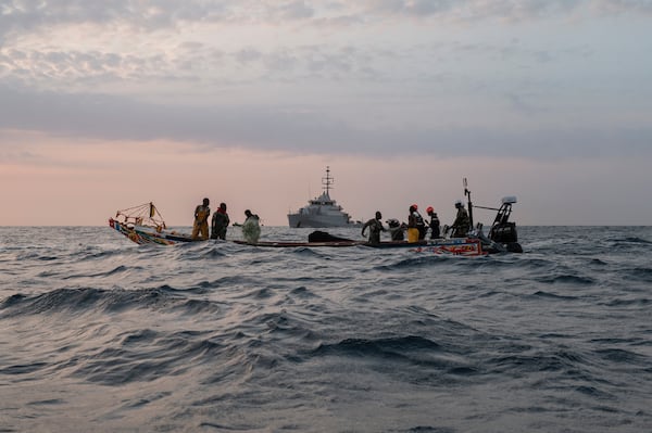 Senegalese sailors in their zodiac, background, approach a fishermen's pirogue to check during a mission to search for illegal migrant boats near the coast of Dakar, Senegal, Saturday, Nov.16, 2024. (AP Photo/Sylvain Cherkaoui)