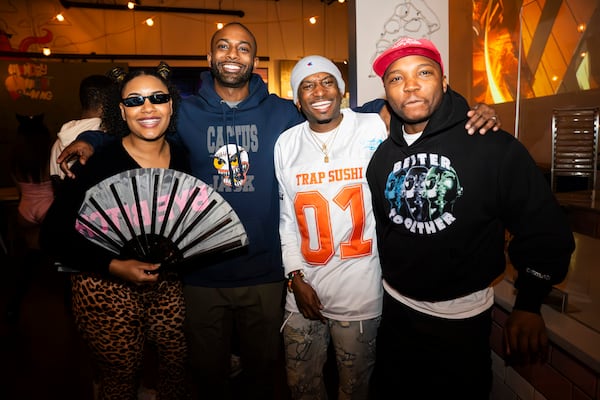 Stephanie Williams, Ryan Johnson, Tolden "Troop" Williams, and Chris Peay celebrate Cxmmunity Media's partnership with local event brand Trap Sushi  at Monday Night Garage in Atlanta Georgia, on Friday, Feb. 23, 2024. (Olivia Bowdoin for the AJC). 