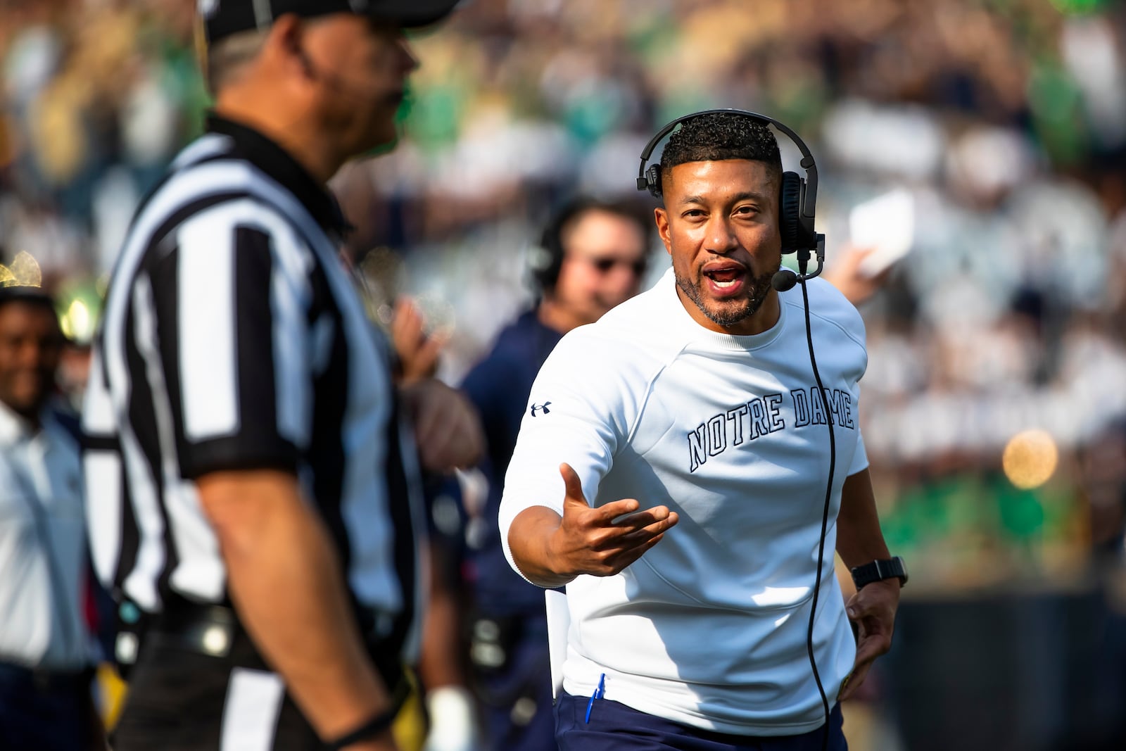 Notre Dame head coach Marcus Freeman, right, shouts toward a referee during an NCAA college football game against Stanford, Saturday, Oct. 12, 2024, in South Bend, Ind. (AP Photo/Michael Caterina)