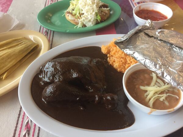 The chicken mole is a wonderful way to sample the traditional Oaxacan fare at Taqueria La Oaxaqueña in Jonesboro. Above left: a tamale with pork and green salsa and a sope with lengua. CONTRIBUTED BY WENDELL BROCK