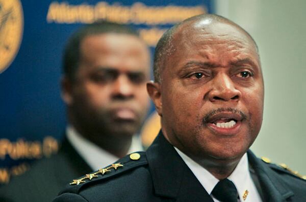 Mayor Kasim Reed listens to Atlanta Police Department Chief George Turner announce on Monday, Feb. 7, 2011, that he is disbanding the controversial Red Dog narcotics unit.