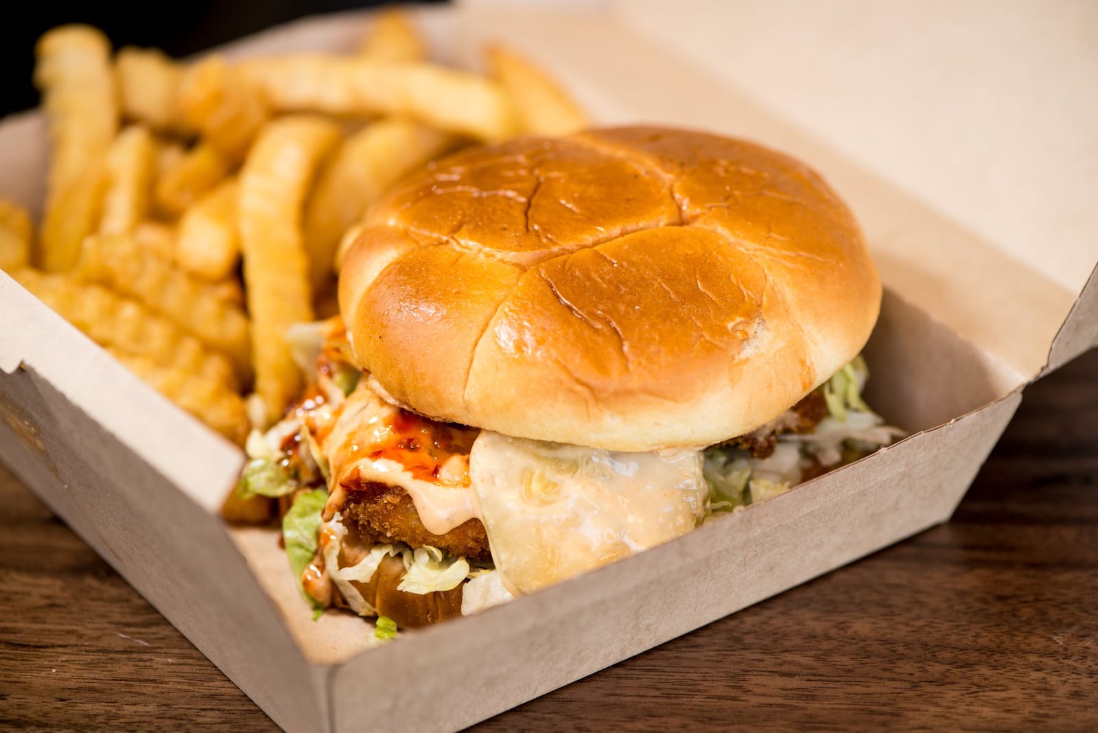 The Fussy Hussy is a plant-based patty with American cheese, shredded lettuce, onion, pickle and vegan mayo on a Hawaiian bun. Photo credit- Mia Yakel.