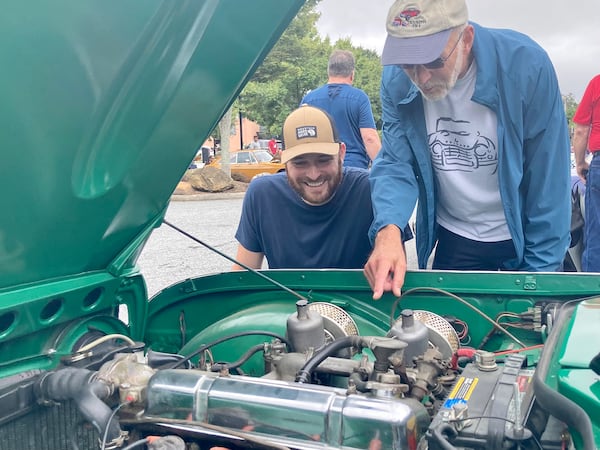 Mike Deadman-Mercer and his son, Jeremy Deadman-Mercer, are Brits who have fond memories of Queen Elizabeth. "It's the end of an era," said the elder Deadman-Mercer. They attended the recent Atlanta British Car Fayre in Norcross. (Mark Davis / For The Atlanta Journal-Constitution)