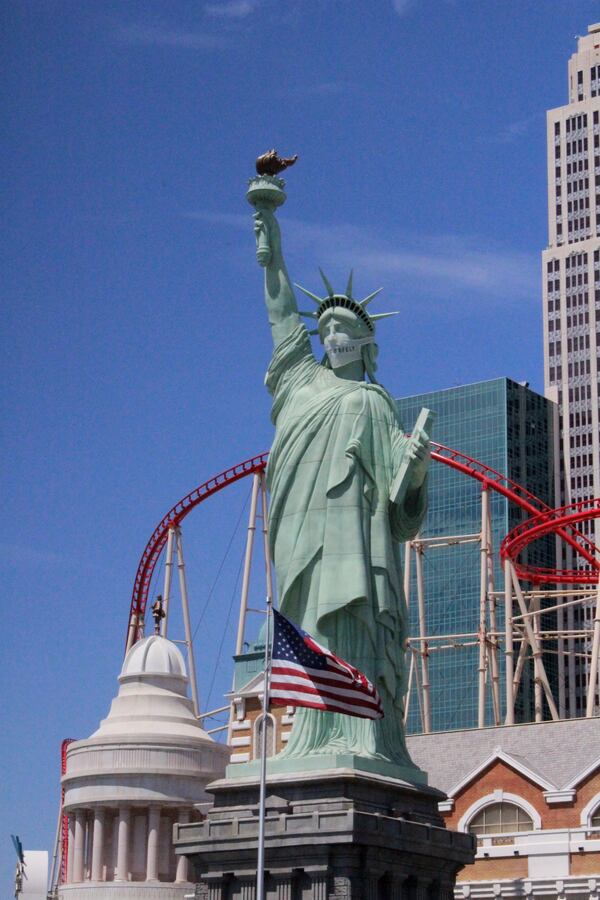 The Statue of Liberty in front of New York-New York Hotel Casino in Las Vegas shows off a mask that tells visitors of doing "Vegas Safely."