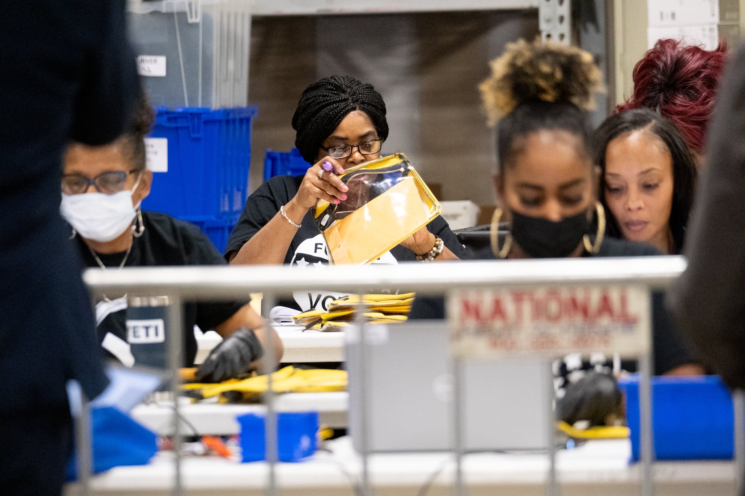 Fulton County elections workers process incoming ballots at the Fulton County Election Preparation Center after polls closed Tuesday, Dec. 6, 2022.  Ben Gray for the Atlanta Journal-Constitution