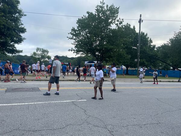 Volunteers greet runners at the finish line of The Atlanta Journal-Constitution Peachtree Road Race.