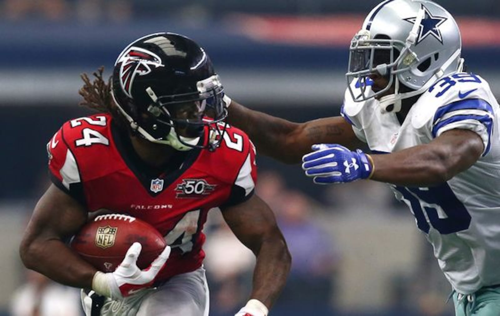 ARLINGTON, TX - SEPTEMBER 27: Devonta Freeman #24 of the Atlanta Falcons is pursued by Brandon Carr #39 of the Dallas Cowboys in the second quarter at AT&amp;T Stadium on September 27, 2015 in Arlington, Texas. (Photo by Tom Pennington/Getty Images)