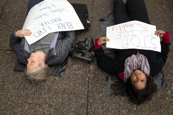 Protesters participate in a “Die-In” outside of the DeKalb County Courthouse on Wednesday. The protestors, who are in support of a maximum sentence for former DeKalb County Police Officer Robert “Chip” Olsen, laid on the ground as passerby’s viewed them for 26 minutes. The 26 minutes represented the 26 years that Anthony Hill lived. (Alyssa Pointer/Atlanta Journal Constitution)