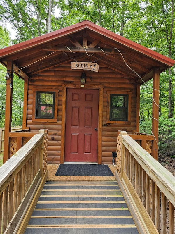 This is the 'Boris' cabin, home to 6 tiny dogs. Each cabin has its own fully fenced large yard, is stepless and fully furnished with soft beds and rugs to feel like home. Photo courtesy of Penny Miller