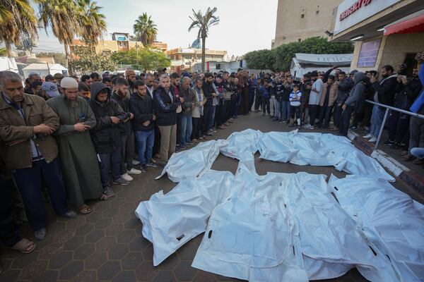 Palestinians pray over the civilian victims of an Israeli army strike on the Nuseirat refugee camp, at the Al-Aqsa Martyrs hospital in Deir al-Balah, Gaza Strip, Thursday Dec. 12, 2024. Palestinian medical officials say Israeli airstrikes have killed at least 28 people in the Gaza Strip, including seven children and a woman. (AP Photo/Abdel Kareem Hana)