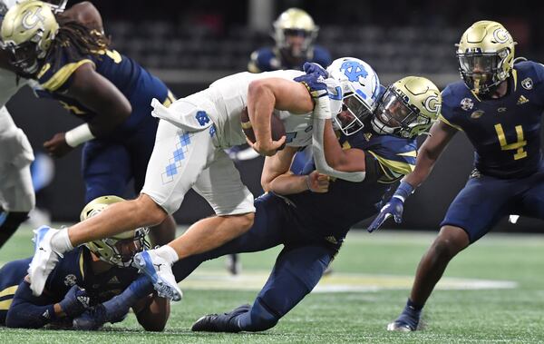 North Carolina quarterback Sam Howell (7) is sacked by Georgia Tech defensive lineman Kyle Kennard (31) during the second half Saturday, Sept. 25, 2021, at Mercedes-Benz Stadium in Atlanta. (Hyosub Shin / Hyosub.Shin@ajc.com)