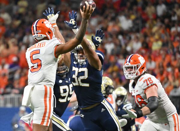 September 5, 2022 Atlanta - Clemson's quarterback DJ Uiagalelei (5) gets off a pass under pressure from Georgia Tech's defensive lineman Sylvain Yondjouen (32) during the second half of Chick-fil-A Kickoff Game at Mercedes-Benz Stadium in Atlanta on Monday, September 5, 2022. Clemson won 41-10 over Georgia Tech. Yondjouen, a program representative at this summer’s ACC Kickoff, has a torn ACL and will miss the remainder of the season, according to coach Brent Key.(Hyosub Shin / Hyosub.Shin@ajc.com)