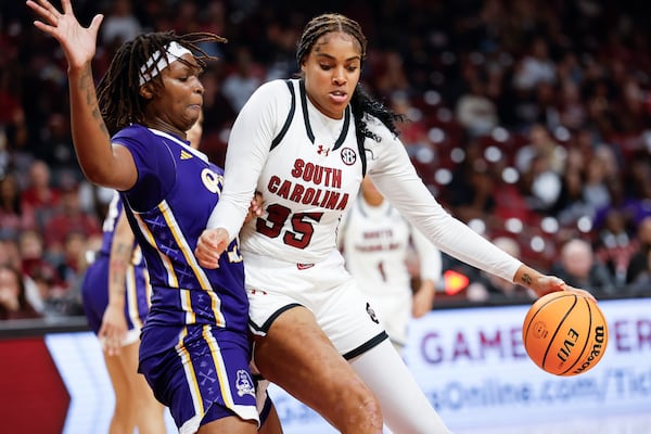 South Carolina center Sakima Walker (35) drives against East Carolina forward Amiya Joyner, left, during the second half of an NCAA college basketball game in Columbia, S.C., Sunday, Nov. 17, 2024. (AP Photo/Nell Redmond)