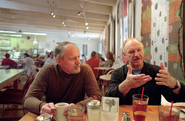 FILE - Gene Hackman, right, and long-time friend Daniel Lenihan, discuss their new book, "Wake of the Perdido Star," on Nov. 19, 1999, in Cloudclift Bakery, the cafe where they first dreamed up their adventure story, in Santa Fe, N.M. (AP Photo/Sarah Martone, File)