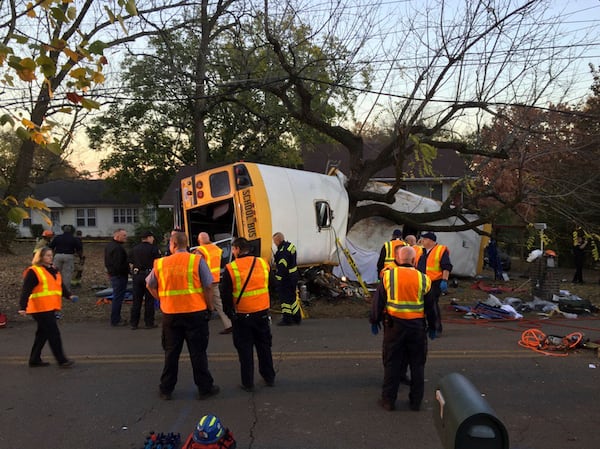 In this photo provided by the Chattanooga Fire Department via Chattanooga Times Free Press, Chattanooga Fire Department personnel work the scene of a fatal elementary school bus crash in Chattanooga, Tenn., Monday, Nov. 21, 2016. In a news conference Monday, Assistant Chief Tracy Arnold said there were multiple fatalities in the crash. 