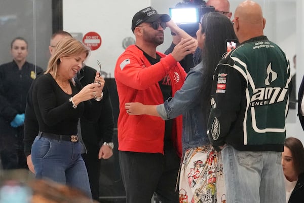 Enrique Tarrio hugs supporters after arriving at Miami International Airport, Wednesday, Jan. 22, 2025, in Miami. Tarrio was pardoned by President Donald Trump after he was convicted of seditious conspiracy for his role in the January 6 attack on the U.S. Capitol. (AP Photo/Marta Lavandier)