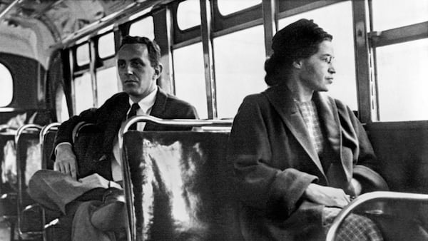 Rosa Parks, who was arrested Dec. 1, 1955, when she refused to give up her seat for a white passenger, is seated toward the front of the bus in Montgomery, Ala., in 1956. CONTRIBUTED BY UNDERWOOD ARCHIVES / GETTY IMAGES