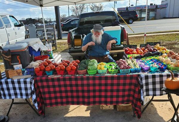 A farmer sells produce at the International City Farmers Market in Warner Robins. The market partners with several organizations to help feed the homeless. (Facebook)