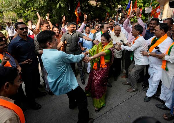 Bhartiya Janata Party workers celebrates after leading in Maharashtra state assembly elections outside party office in Mumbai, India, Saturday, Nov 23, 2024.(AP Photo/Rajanish Kakade)