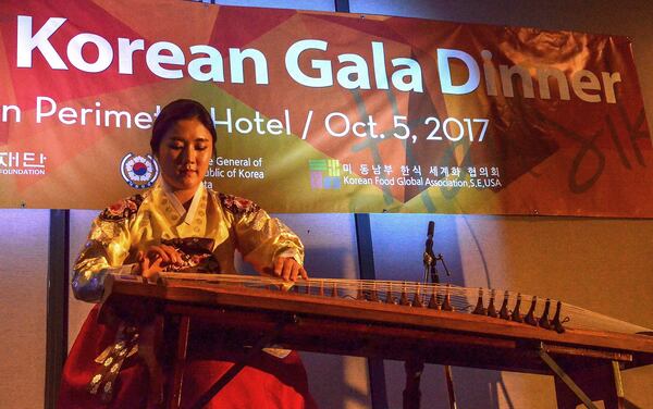 Eun Kyung Park plays a Gaygeum (Korean zither) for attendees of a five-course dinner event introducing metro Atlantans to “Chuseok,” an annual harvest feast similar to America’s Thanksgiving celebration. The Consulate General of the Republic of Korea in Atlanta invited more than 100 influential guests from Georgia — including lawmakers, business executives and food bloggers — to the dinner to experience Korean food and culture and celebrate the Chuseok holiday. The gala was held Oct. 5, 2017, at the Westin Atlanta Perimeter North. (Chris Hunt/Special for The AJC)