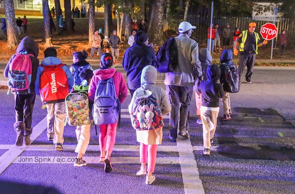 Children crossed a road where a 4-year-old girl was killed in a hit-and-run  in DeKalb County. JOHN SPINK / JSPINK@AJC.COM