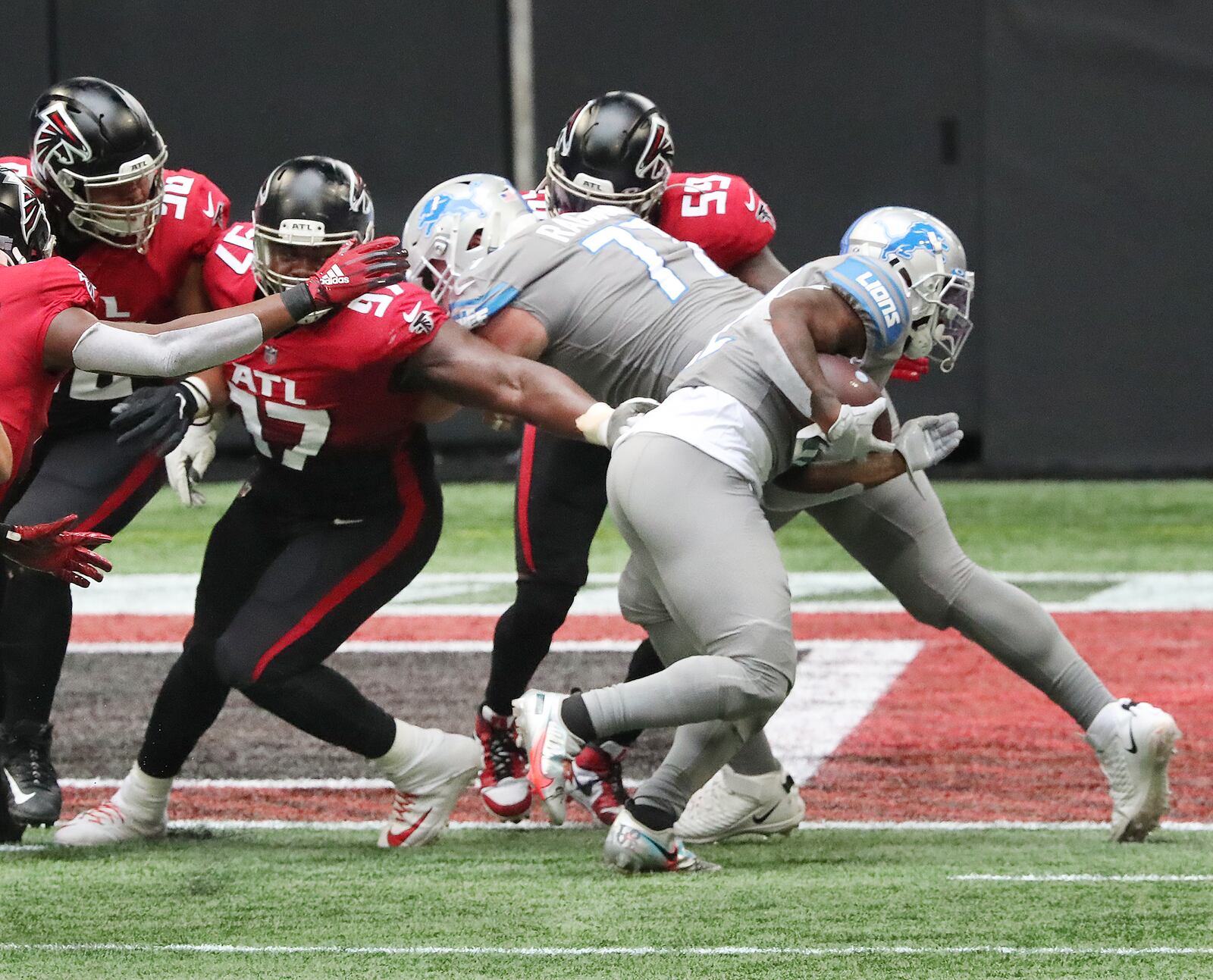 Lions running back D’Andre Swift (right) slips away from the grasp of Falcons defender Grady Jarrett for a touchdown in the first quarter Sunday, Oct. 25, 2020, at Mercedes-Benz Stadium in Atlanta. (Curtis Compton / Curtis.Compton@ajc.com)