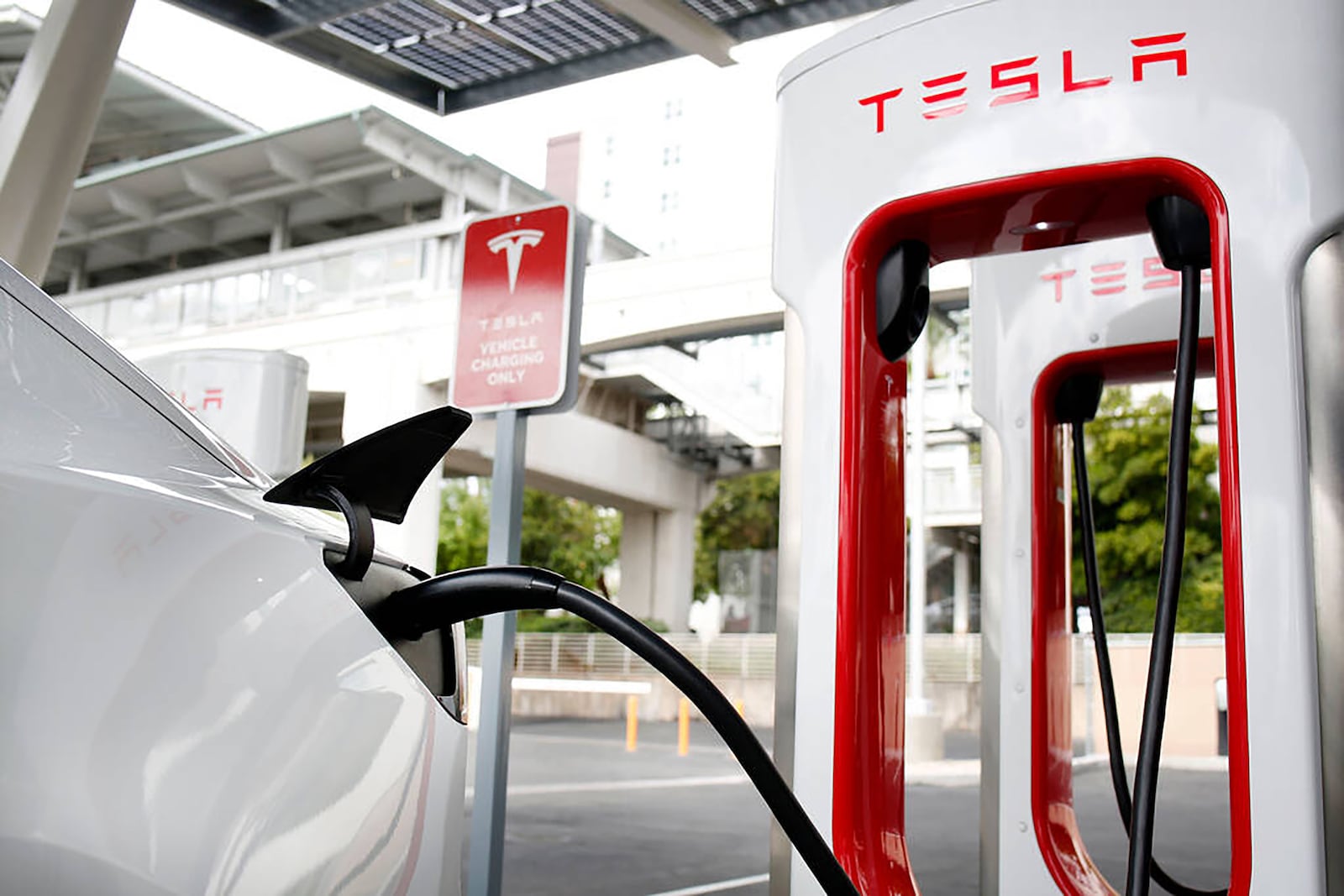 A Tesla Model 3 electric vehicle charges at a Tesla Supercharger station near the High Roller in Las Vegas. In recent years, Georgia has become a mecca of EV, battery and solar manufacturing. (Elizabeth Page Brumley/Las Vegas Review-Journal/TNS 2019)