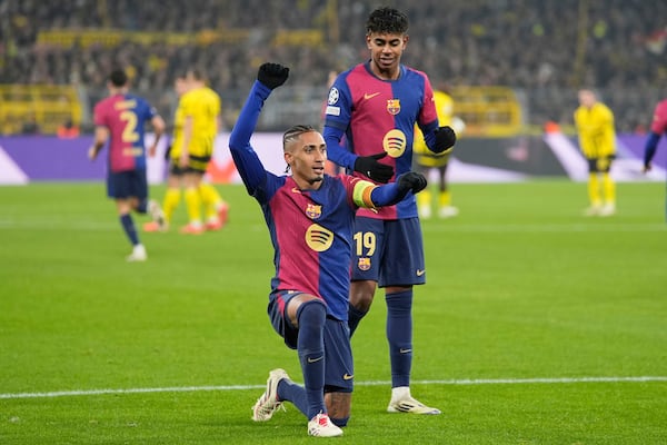 Barcelona's Raphinha celebrates the opening goal during the Champions League opening phase soccer match between Borussia Dortmund and FC Barcelona at the Signal-Iduna Park in Dortmund, Germany, Wednesday Dec. 11, 2024. (AP Photo/Martin Meissner)