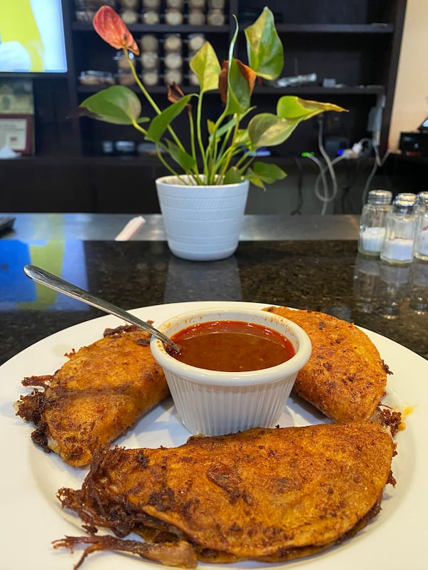 Birria tacos are a taco-quesadilla hybrid, with birria-style beef and cheese stuffed inside a tortilla that is folded, dipped in beef consommé, then fried until crispy. Ligaya Figueras/ligaya.figueras@ajc.com