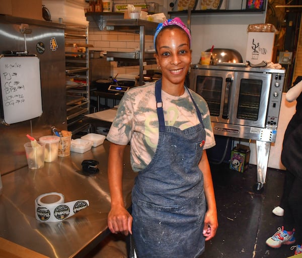 Erika Council, baker-owner of Bomb Biscuits, poses at her stall inside Irwin Street Market in November 2021. Later this fall, Council will be moving to a new location at 668 Highland Ave. (Chris Hunt for The Atlanta Journal-Constitution)