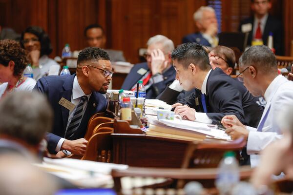 (Left to right) Rep. Phil Olaleye (D-Atlanta) and Rep. Sam Park (D-Lawrenceville) chat on Sine Die at the State Capitol on Wednesday, March 29, 2023.  (Natrice Miller/ natrice.miller@ajc.com)