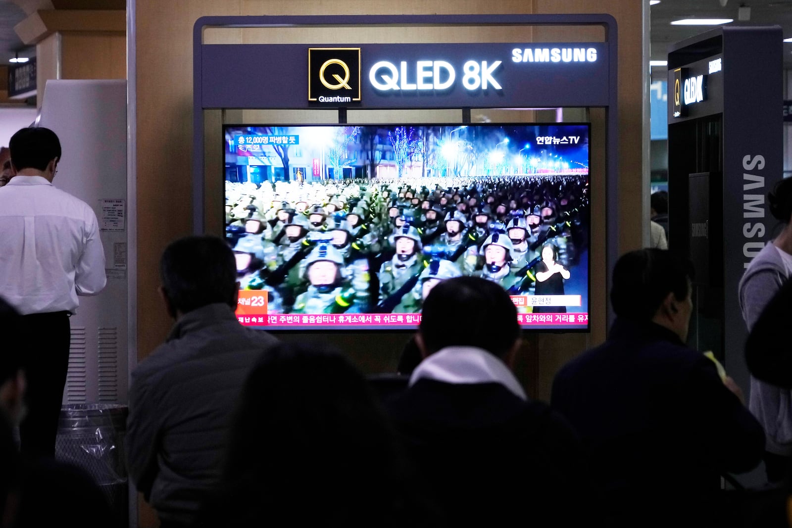 A TV screen shows file images of North Korean soldiers during a news program at Seoul Railway Station in Seoul, South Korea, Friday, Oct. 18, 2024. (AP Photo/Ahn Young-joon)