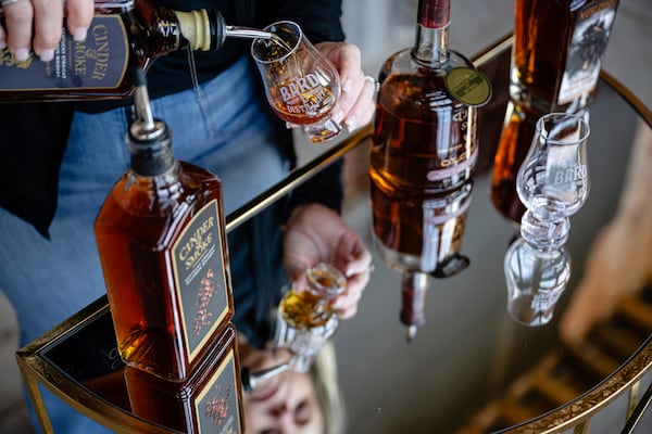 An employee pours a glass of The Bard's product in what will be a new production area at The Bard Distillery in Graham, Ky., Sunday, March 9, 2025. (AP Photo/Jon Cherry)