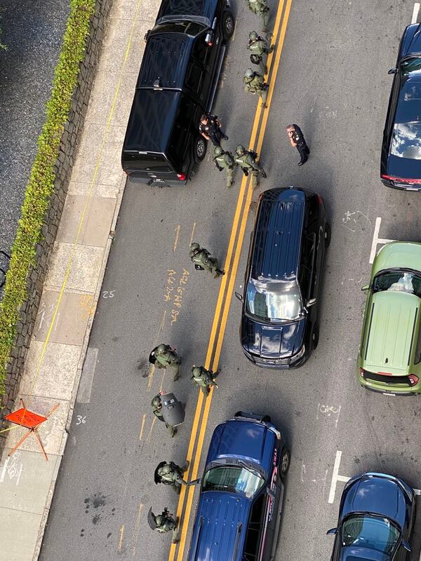 Midtown residents looked on from their apartment windows as police flooded Peachtree Street following the officer's shooting in late June.