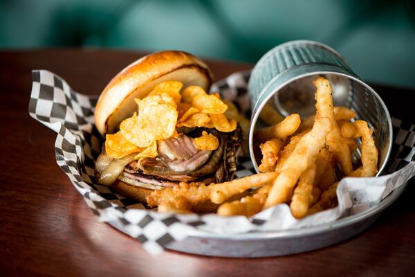 Black Sheep Tavern and Oyster Room Fried Bologna Sandwich with thick-cut bologna, VooDoo chips, shaved onion, stone ground mustard, and house pickles. Photo credit- Mia Yakel.