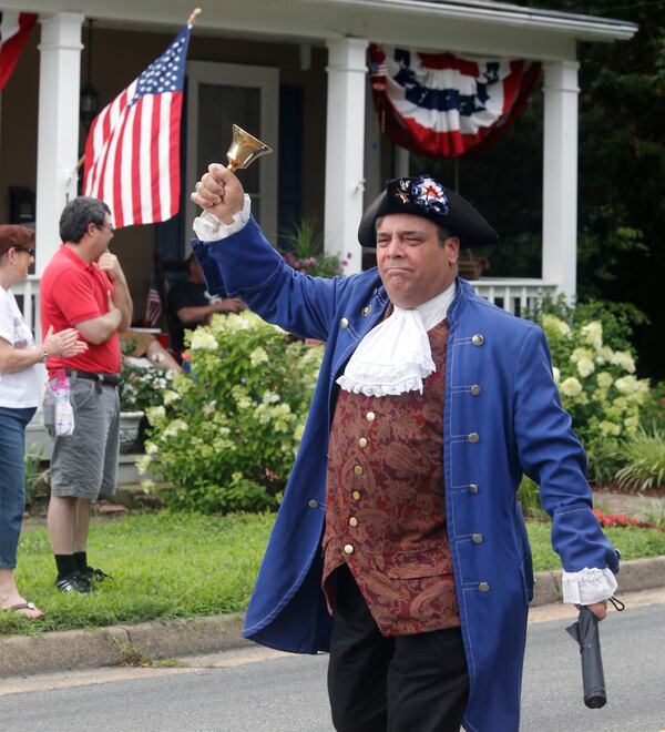 FILE - Ashland, Va. resident John Wallmeyer portraying parriot and native-son Patrick Henry, marches during the annual 4th of July parade in Ashland, Virginia, on July 4, 2015. (Joe Mahoney/Richmond Times-Dispatch via AP, File)