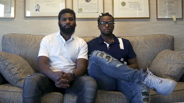 Rashon Nelson, left, and Donte Robinson, right, both 23, sit on their attorney's sofa as they pose for a portrait following an interview with the Associated Press Wednesday April 18, 2018 in Philadelphia.