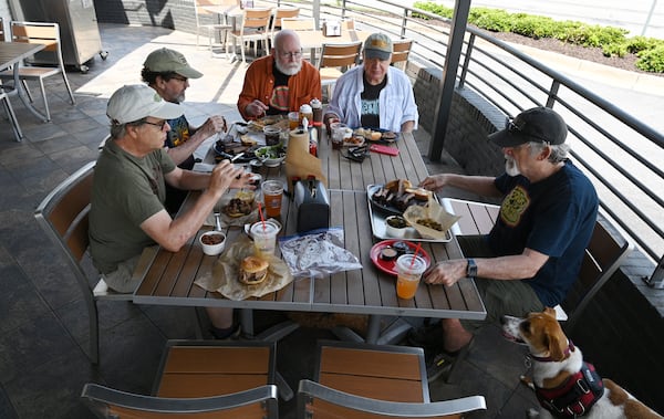 Members of Trailheads (clockwise from left) Patrick Scullin, George Hirthler, Roy Trimble, Guy Tucker and Brad Copeland end their hike with a feast at City Barbeque in Sandy Springs. (Hyosub Shin / Hyosub.Shin@ajc.com)