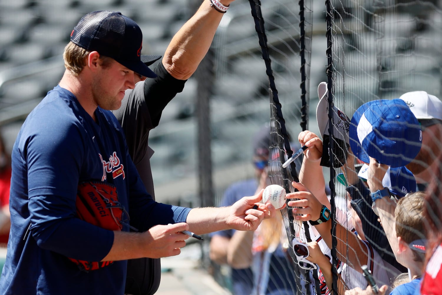 Braves pitcher Bryce Elder (55) signs balls to fans before the game against the Astros at Truist Park, Sunday, April 23, 2023, in Atlanta. 
 Miguel Martinez / miguel.martinezjimenez@ajc.com 