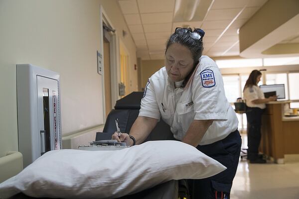 A paramedic in Wilkes County receives information from a dispatcher inside the Wills Memorial Hospital emergency room following a call. 