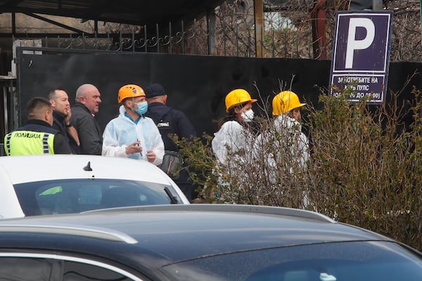 Police officers investigate a nightclub after a massive fire in the town of Kocani, North Macedonia, Sunday, March 16, 2025. (AP Photo/Boris Grdanoski)