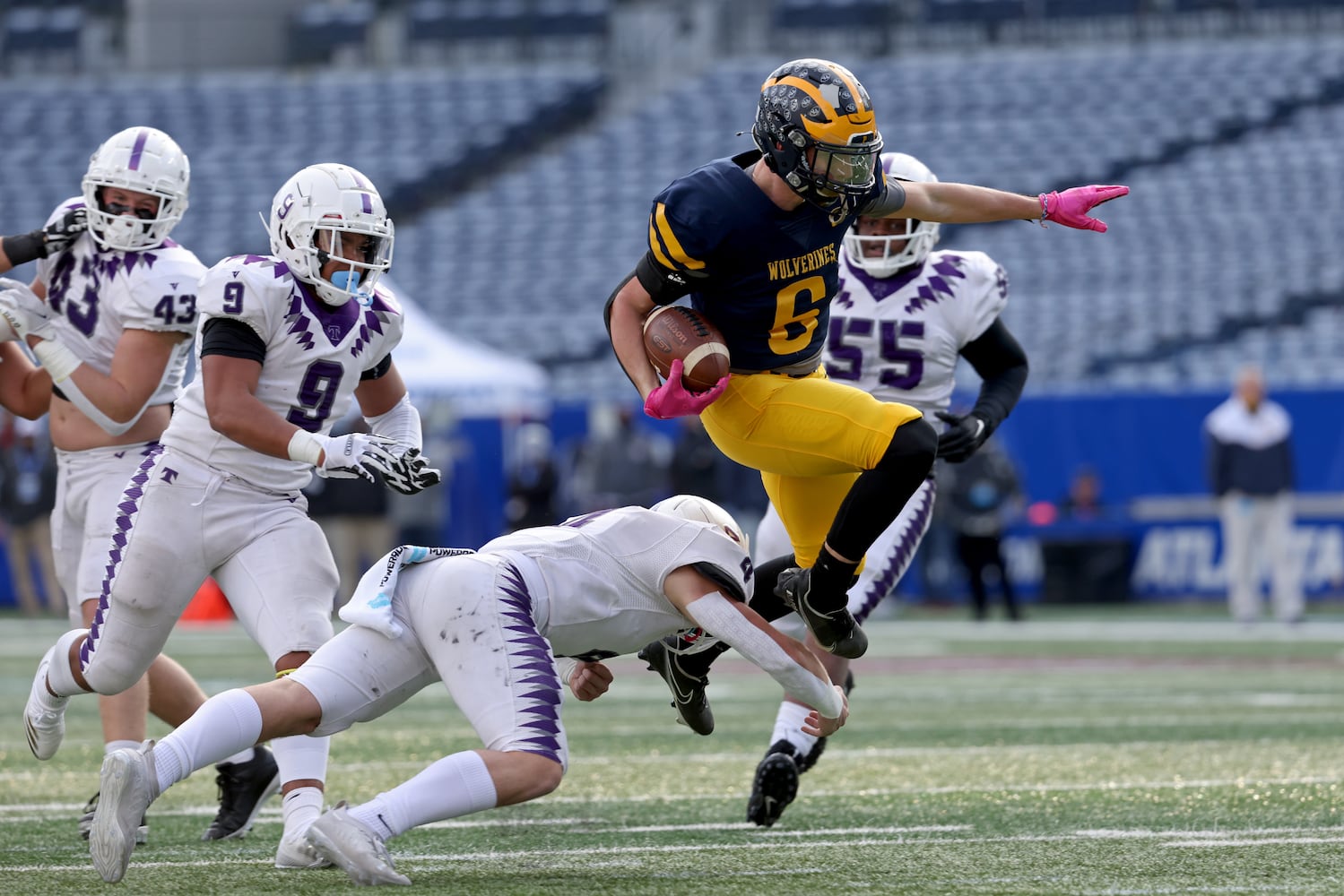 Prince Avenue Christian wide receiver Landon Owens (6) leaps on a tackle attempt by Trinity Christian linebacker Jimbo Batchelor (4) during the Class 1A Private championship at Center Parc Stadium Monday, December 28, 2020 in Atlanta, Ga.. JASON GETZ FOR THE ATLANTA JOURNAL-CONSTITUTION