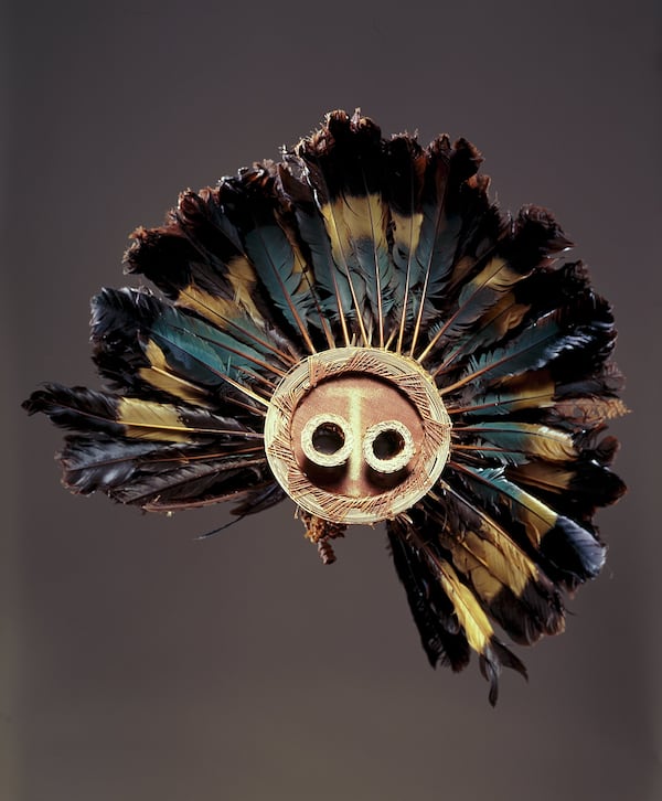 This is a Pende mask from the Democratic Republic of the Congo. The piece was made in the late-19th or early-20th century, of great blue turaco feathers, fiber, and wood. It's part of the High Museum of Art's African Art collection.