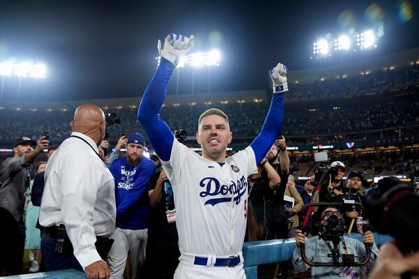 Los Angeles Dodgers' Freddie Freeman celebrates after hitting a game-winning grand slam against the New York Yankees during the 10th inning in Game 1 of the baseball World Series, Friday, Oct. 25, 2024, in Los Angeles. The Dodgers won 6-3. (AP Photo/Godofredo A. Vásquez)