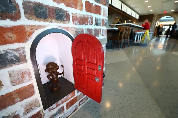 A bronze statuette of one of the original cooks, known as "Master of the Grill" is seen tucked inside a miniature door in one of the walls inside the newly renovated Dwarf House. There are 15 similar "dwarf" statuettes scattered throughout the building.
  “Curtis Compton / Curtis.Compton@ajc.com”`